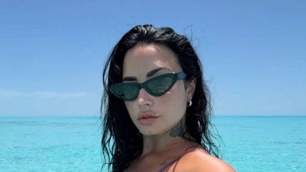 Demi Lovato shows off tattoos in tiny string bikini