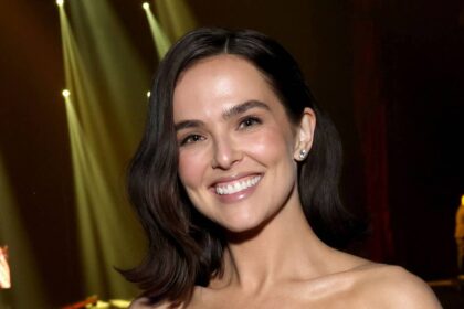 Zoey Deutch shows off impeccably toned abs in black bikini in new photos