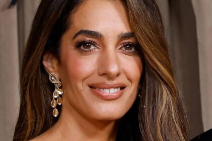 Amal Clooney, 48, shows off toned legs in bold snake-print skirt with jaw-dropping slit