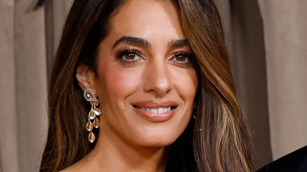 Amal Clooney, 48, shows off toned legs in bold snake-print skirt with jaw-dropping slit