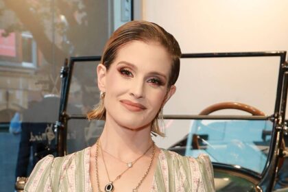 Kelly Osbourne showcases her curves in plunging leopard print swimsuit