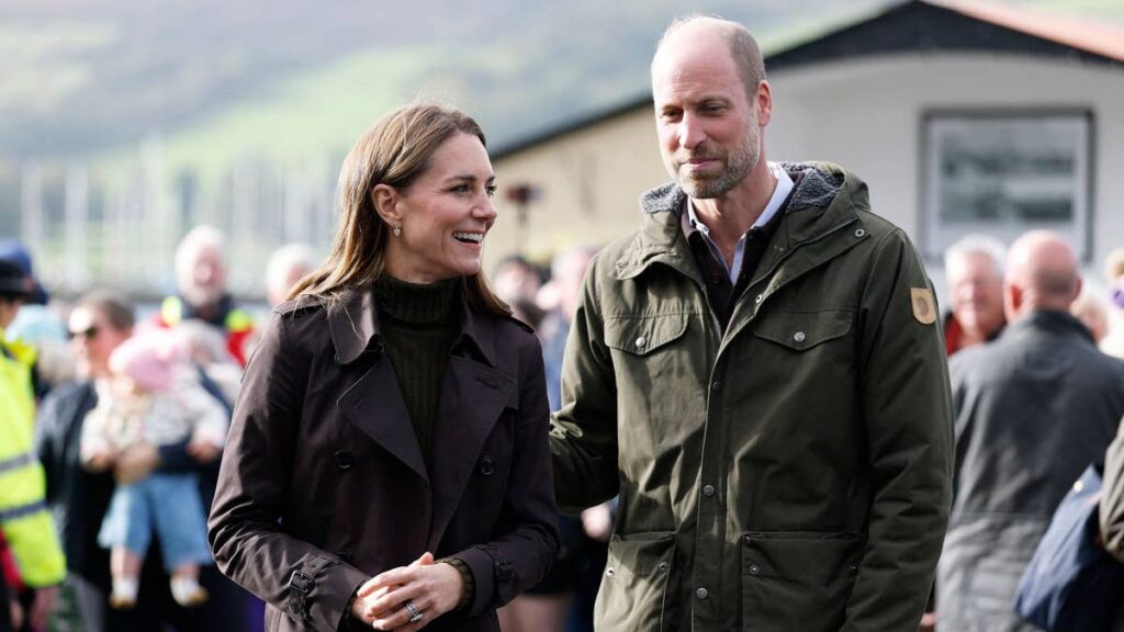 Prince William and Princess Kate get their hands dirty at the beach during horizontal rain