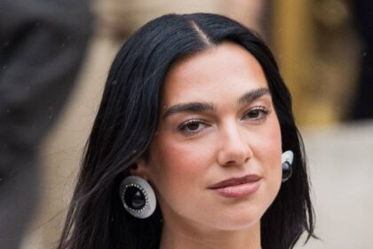 Dua Lipa exposes lace bra in ultimate naked dress with feathers