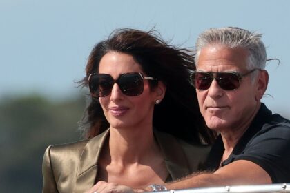 George and Amal Clooney look straight out of a romantic film as they arrive in Venice