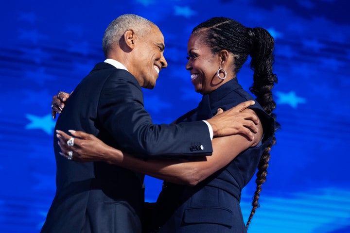 Former President Barack Obama and former first lady Michelle Obama appear on stage in between their addresses on the second night of the Democratic National Convention on Aug. 20, 2024.