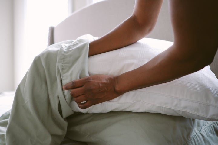 Experts suggest washing your pillowcases and sheets on warm or high heat once a week.