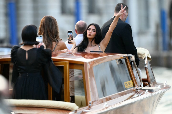 Kris Jenner, Khloé Kardashian and Kim Kardashian stand on a taxi boat as they leave the Gritti Palace Hotel ahead of the wedding of Jeff Bezos and Lauren Sánchez in Venice on Thursday.