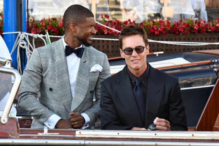 Usher, left, and Tom Brady leave a hotel ahead of the anticipated wedding celebrations of Jeff Bezos and Lauren Sanchez, in Venice, Italy, Friday, June 27, 2025. (AP Photo/Luigi Costantini)
