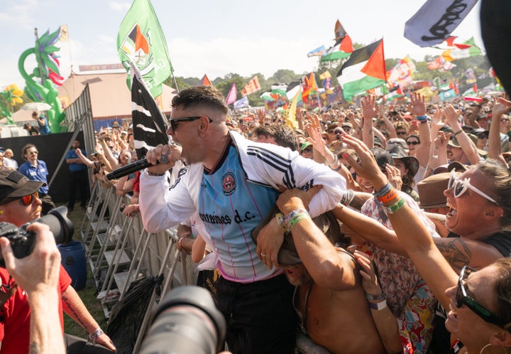 Fans swarn Moglai Bap of Kneecap during the group's Glastonbury set. Britain's biggest music festival regularly draws over 200,000 music fans.