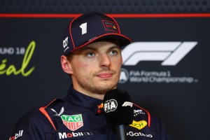 A still image of Max Verstappen in his uniform.